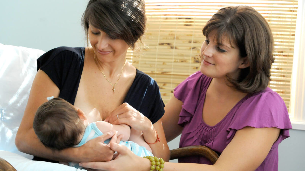 Lactation consultant with breastfeeding mother