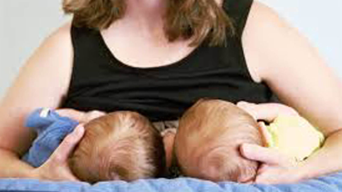 Woman breastfeeding two babies