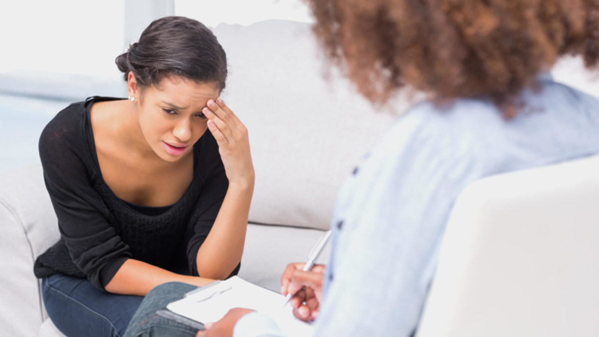 A distressed woman speaking with a counsellor
